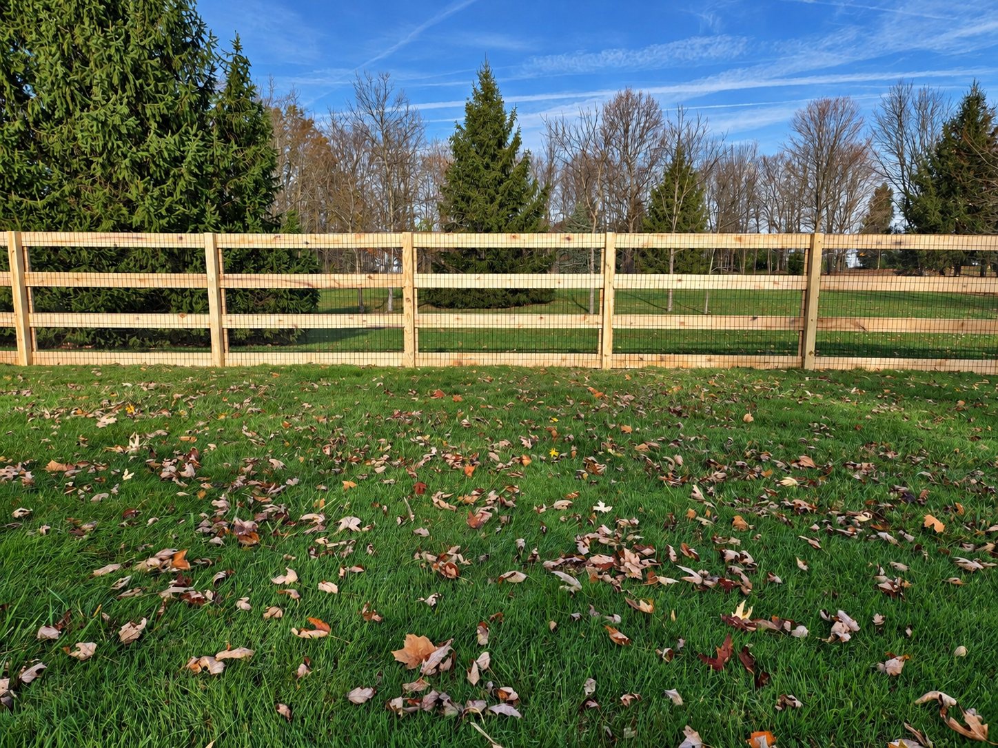 Three rail split rail fence with wire mesh backing installed by Armor Fence of Ohio